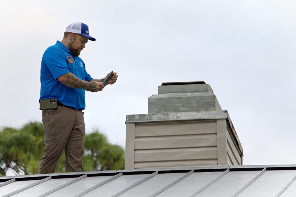 Professional home inspection in North Port, FL, featuring Scott Lundstrom inspecting a residential metal roof and chimney.