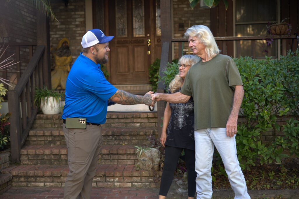 Certified home inspector Scott Lundstrom of Lundstrom Home Inspection shaking hands with satisfied clients after a residential property assessment.